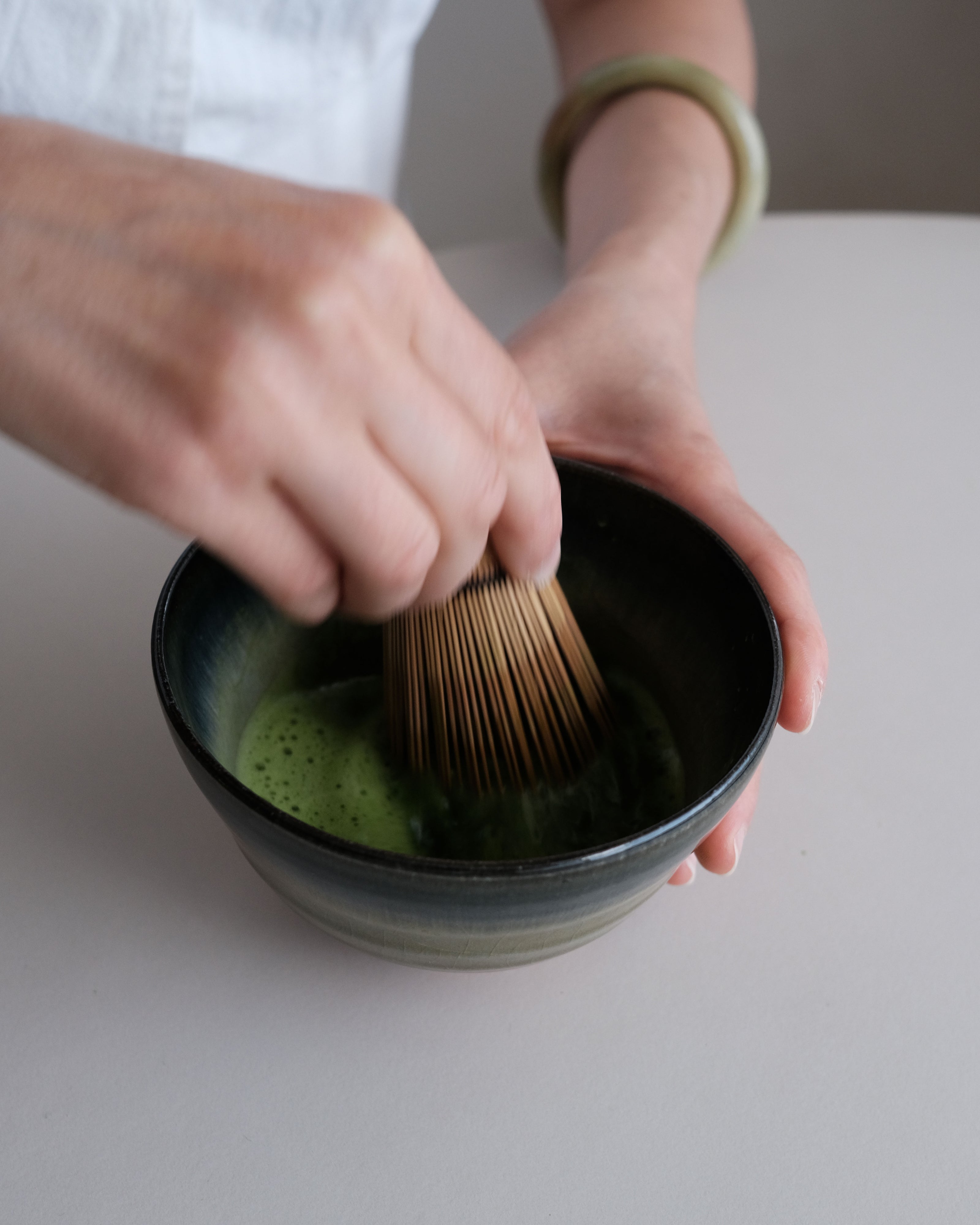ceremonial Japanese matcha being whisked in a traditional tea bowl for a mindful ritual 